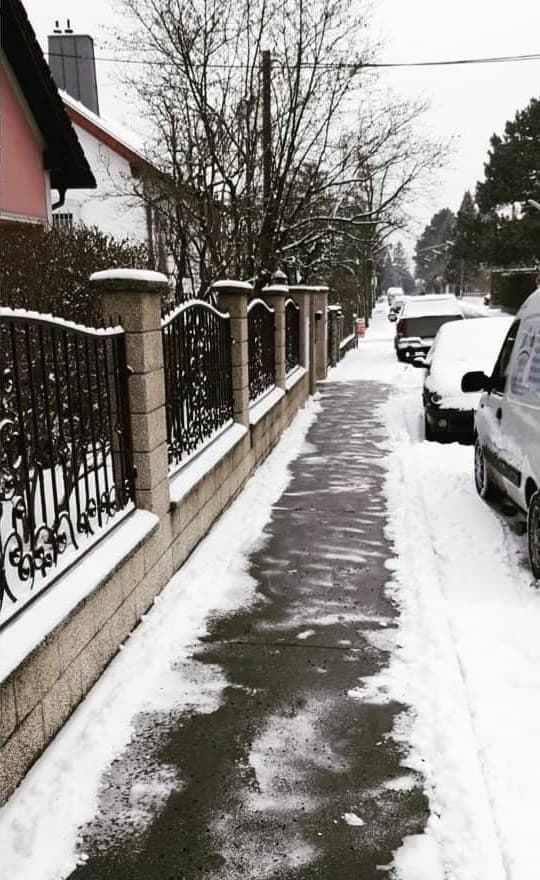 Nachher: derselbe Gehweg geräumt, der Asphalt ist frei, Schnee liegt am Rand
